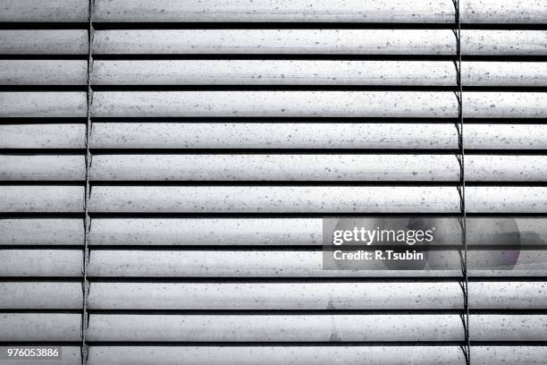 grey shutters over a shop doors - texture - jalousie fotografías e imágenes de stock