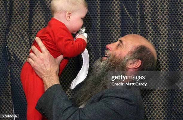 Steven Ayres holds up his grandson Ryan during a press conference in Keynsham on March 10 2010, near Bristol, England. The two plane spotters Stephen...