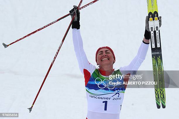 Poland's Justyna Kowalczyk reacts after crossing the finish line in the women's Cross Country skiing 30 km mass start classic at Whistler Olympic...