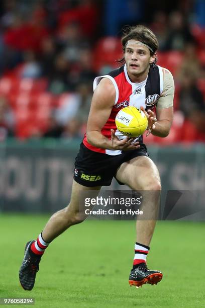 Hunter Clark of the Saints kicks during the round 13 AFL match between the Gold Coast Suns and the St Kilda Saints at Metricon Stadium on June 16,...