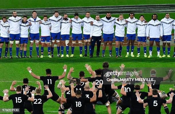 France face New Zealand's players as they perform the "haka" at the start of the second rugby Test match between New Zealand and France at Westpac...