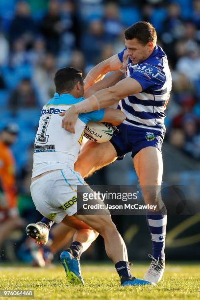 Michael Gordon of the Titans is tackled by Kerrod Holland of the Bulldogs during the round 15 NRL match between the Canterbury Bulldogs and the Gold...