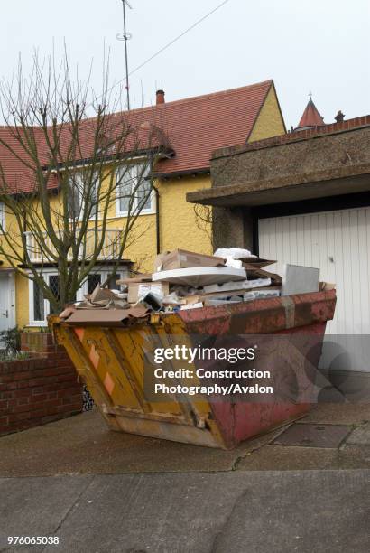 Skip in driveway of residential home.