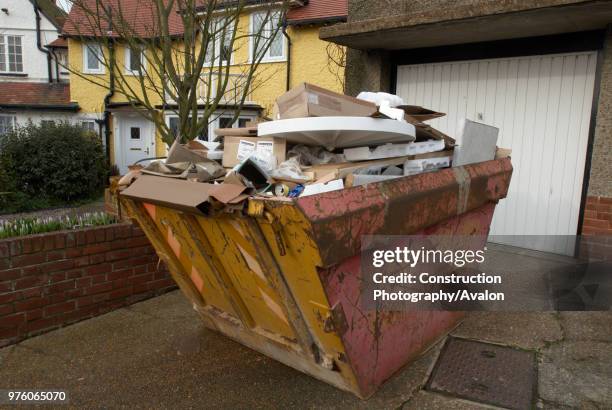 Skip in driveway of residential home.