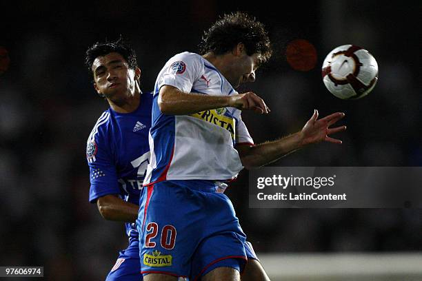 Universidad Catolica's Diego Rossende vies for the ball with Edson Puch of Universidad de Chile during the 2010 Libertadores Cup on March 09, 2010 in...