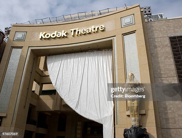 An Academy Awards Oscar statue stands outside the Kodak Theater on Hollwood Boulevard in Los Angeles, California, U.S., on Tuesday, March 2, 2010....