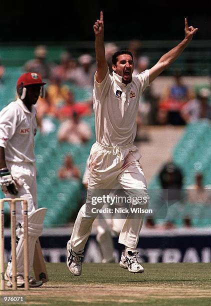 Jason Gillespie of Australia celebrates the wicket of Sherwin Campbell of West Indies caught by Adam Gilchrist for 54 during the fourth days play of...