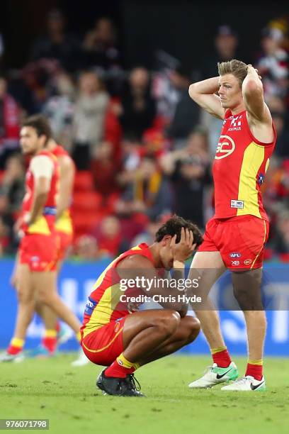 Suns look on after losing the round 13 AFL match between the Gold Coast Suns and the St Kilda Saints at Metricon Stadium on June 16, 2018 in Gold...