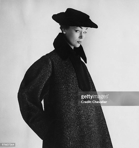 Woman modelling a grey wool coat, with black velvet trim and matching hat, by Castillo at Lanvin, October 1951. Original publication: Picture Post -...