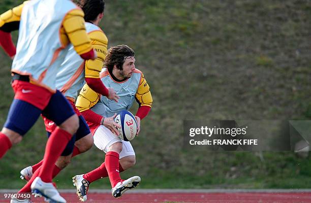 France's rugby union national team winger Marc Andreu runs with a ball during a training session, on March 10, 2010 in Marcoussis, south of Paris, as...