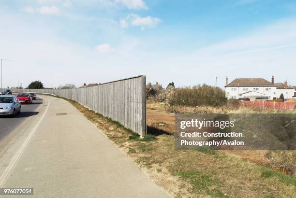 Noise barrier fence protecting homes from a nearby busy road, Kings Lynn, Norfolk, UK.