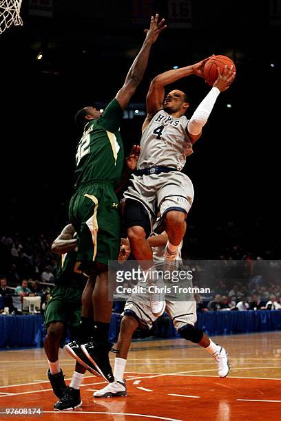 Chris Wright of the Georgetown Hoyas goes to the hoop against Toarlyn Fitzpatrick of the USF Bulls during the second round of 2010 NCAA Big East...