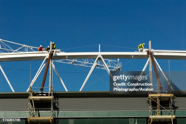 Construction workers fix roof truss to roof of Centre Court, All England Lawn Tennis Club, Wimbledon, London, UK, 2008.