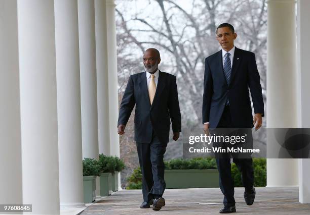 President Barack Obama walks with Haitian President Rene Preval after meeting in the Oval Office at the White House March 10, 2010 in Washington, DC....