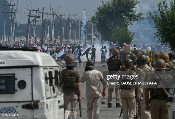 Kashmiri youths throw stones during clashes between protesters and Indian government forces in Srinagar on June 16, 2018. - Clashes broke out after...