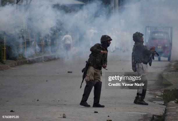 Tear gassed Kashmiri Muslim protesters throw stones at Indian government forces after prayers on Eid-ul-Fitr, a festival of Muslims on June 16, 2018...