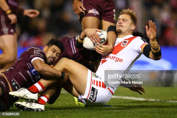 Jack de Belin of the Dragons is tackled during the round 15 NRL match between the St George Illawarra Dragons and the Manly Sea Eagles at WIN Stadium...
