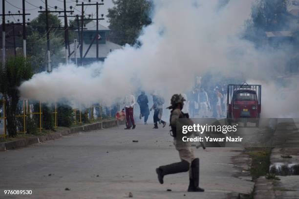 Tear gassed Kashmiri Muslim protesters throw stones at Indian government forces after prayers on Eid-ul-Fitr, a festival of Muslims on June 16, 2018...