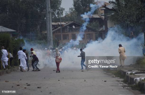 Tear gassed Kashmiri Muslim protesters throw stones at Indian government forces after prayers on Eid-ul-Fitr, a festival of Muslims on June 16, 2018...