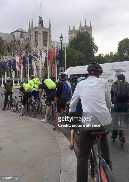 May 2018, United Kingdom, London: Cyclists waiting at a red light near Westminster. Cycling is environmentally conscious and promotes good health....