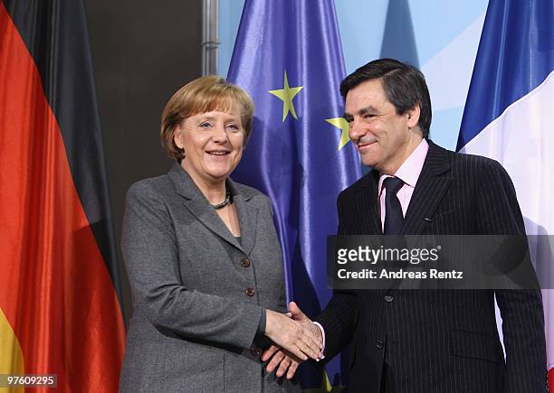 German Chancellor Anglea Merkel shakes hands with French Prime Minister Francois Fillon after a press conference at Chancellery on March 10, 2010 in...