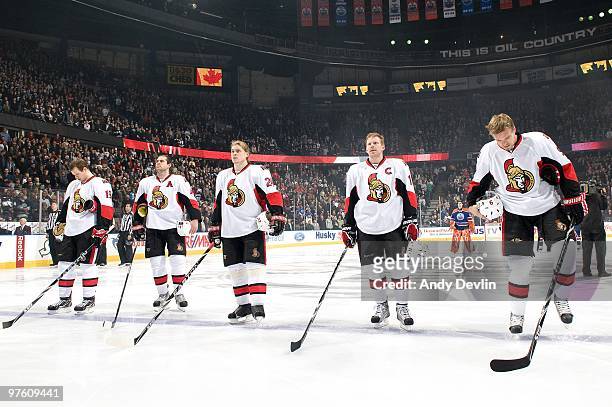 Jason Spezza, Chris Phillips, Anton Volchenkov, Daniel Alfredsson and Milan Michalek of the Ottawa Senators stand for the anthem before a game...
