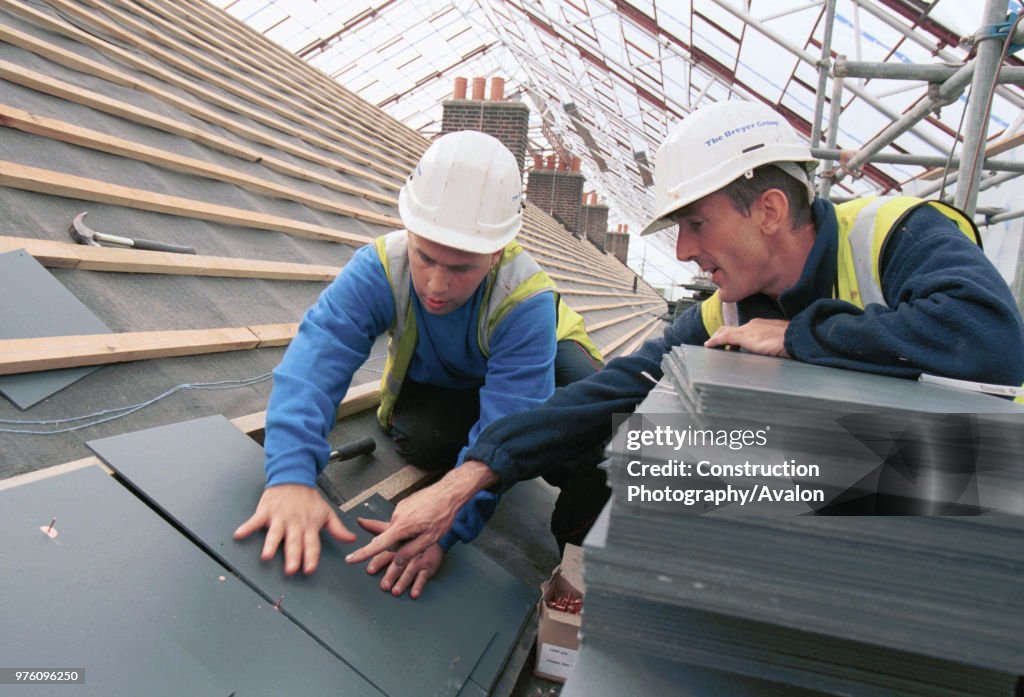 Roof SlatingYoung apprentice learning trade skills on site
