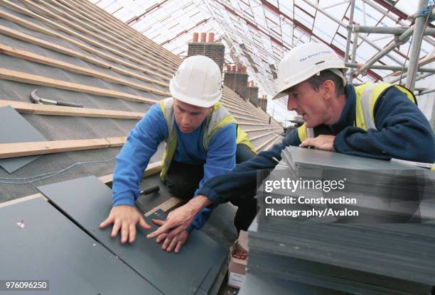 Roof SlatingYoung apprentice learning trade skills on site, News Photo