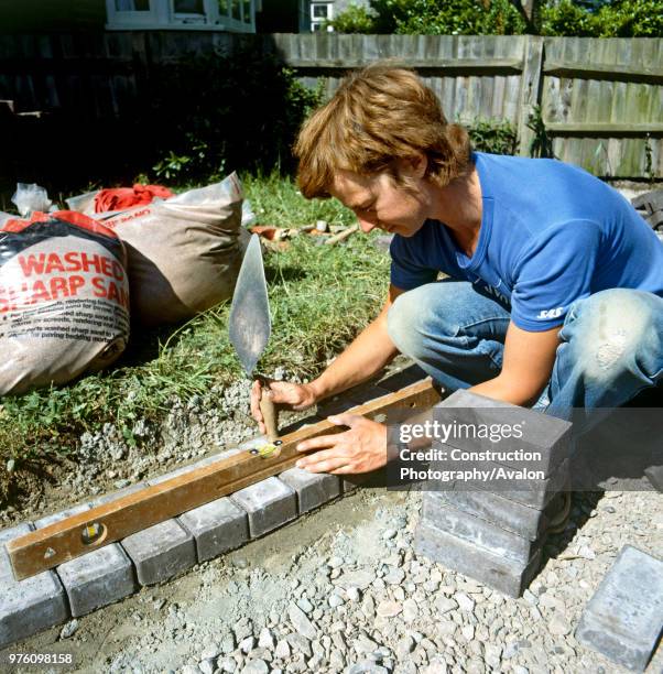 Laying paving stones in a front garden.