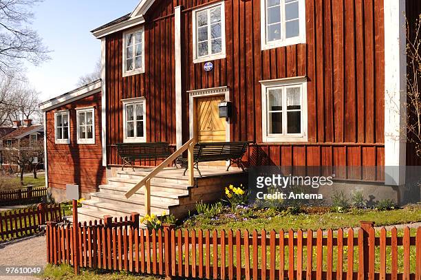 traditional swedish house in astrid lindgren style - blue house red door stock pictures, royalty-free photos & images