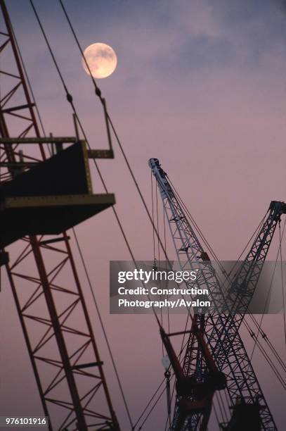 Forest of cranes at moonlight, Canary Wharf, London, United Kingdom.