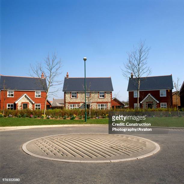 Housing development with detached houses and road safety feature on the estate roundabaout.