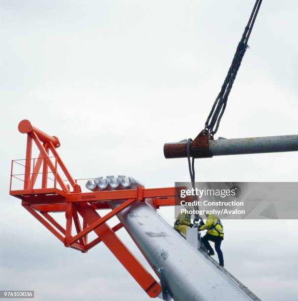 Placing pre-fabricated arms on pier base during the construction of the Millennium Bridge, London, UK.