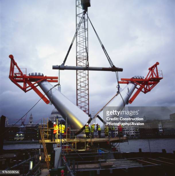 Installation of pre-fabricated arms during construction of the Millennium Bridge, London, UK.