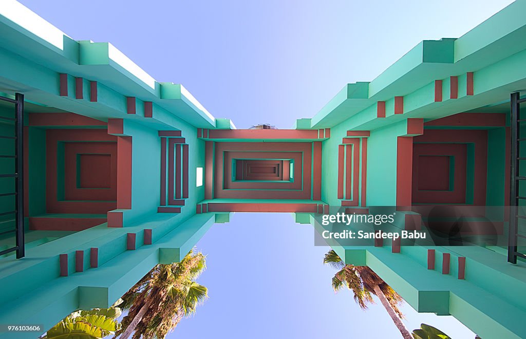 Upward view at architectural details of building on sunny day, Palm Court, Los Angeles, USA