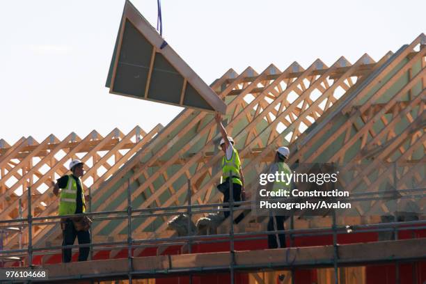 Pre-fabricated section being delivered by crane at new housing development, Cambridge, England, UK.