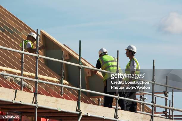 Construction workers installing pre-fabricated section at new housing development, Cambridge, England, UK.