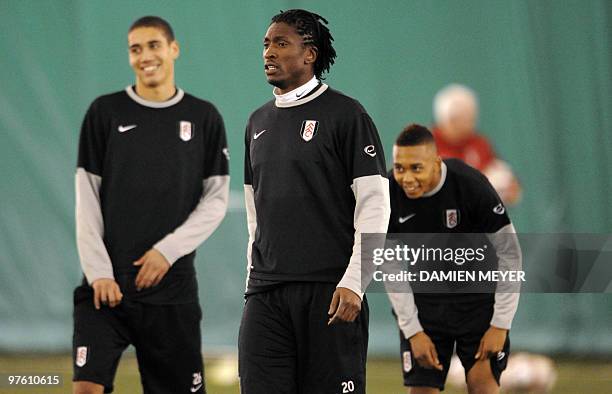 Fulham's Nigerian midfielder Dickson Etuhu attends a training session with Fulham's English defender Chris Smalling and Fulham's Welsh midfielder...