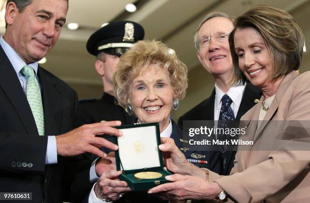 Deanie Parrish of Waco Texas, accepts the Congressional Gold Medal while flanked by House Minority Leader John Boehner , Sen. Harry Reid and Speaker...