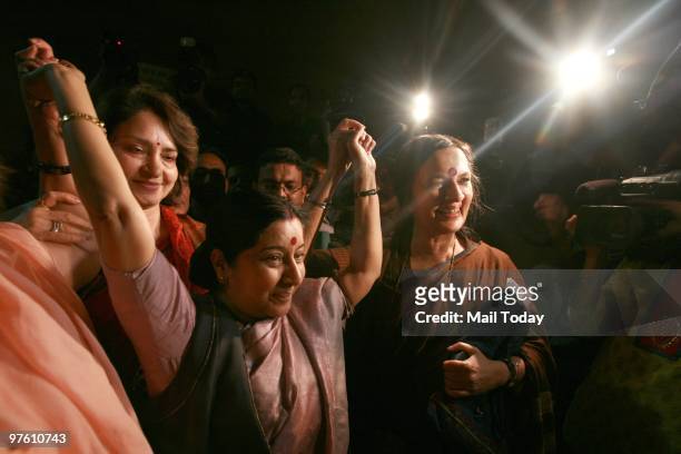 Leader of Opposition in Lok Sabha Sushma Swaraj, Maya Singh and CPI leader Brinda Karat show victory sign as they celebrate the passing of Women's...