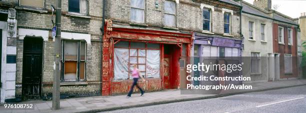 Derelict terraced shop fronts and housing Clapham Common Rectory Grove, London, United Kingdom.