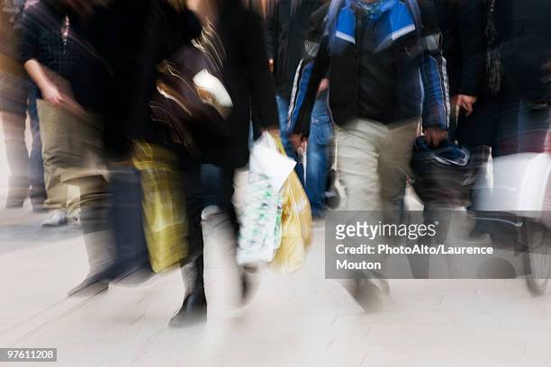 pedestrians walking on sidewalk, blurred - mitziehen stock-fotos und bilder
