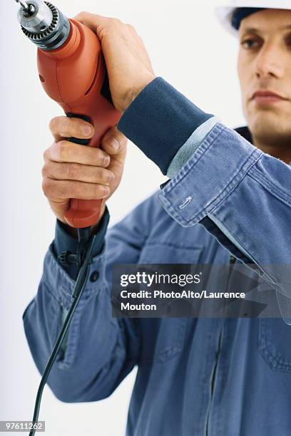 handyman using drill - handyman overalls stock pictures, royalty-free photos & images