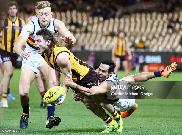 Eddie Betts of the Crows tackles Blake Hardwick of the Hawks during the round 13 AFL match between the Hawthorn Hawks and the Adelaide Crows at...