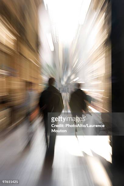 pedestrians walking, rear view, blurred - mitziehen stock-fotos und bilder