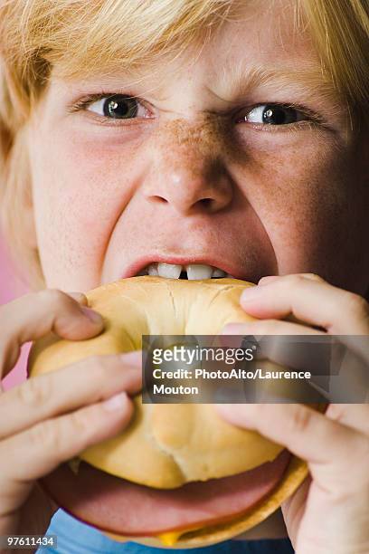 boy biting into ham and cheese bagel sandwich, close-up - human toe bildbanksfoton och bilder