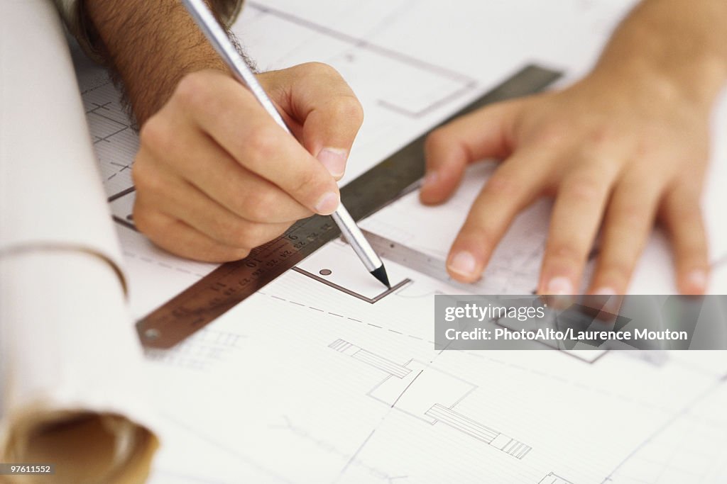 Architect editing blueprint, close-up