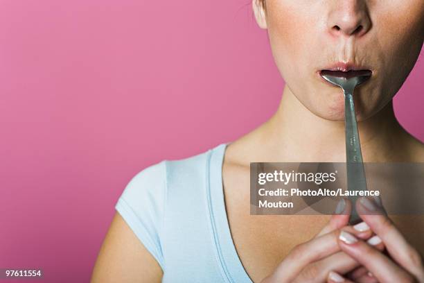 Woman Licking Spoon Cropped, Stock-Foto