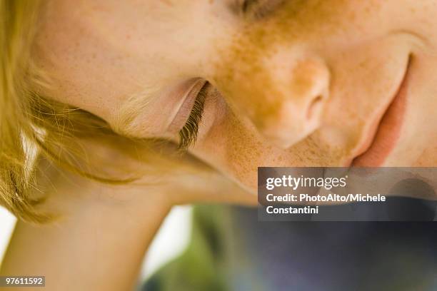 boy holding head and smiling, eyes closed - boy freckle stock pictures, royalty-free photos & images