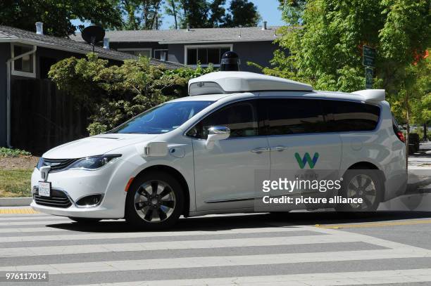 May 2018, US, Mountain View: A self-driving car made by Google's sister company Waymo is on the road for a test drive. The car is a rebuilt minivan...